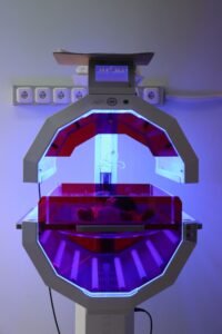 NEC baby formula lawsuit: neonatal incubator unit lit with purple light in a hospital room