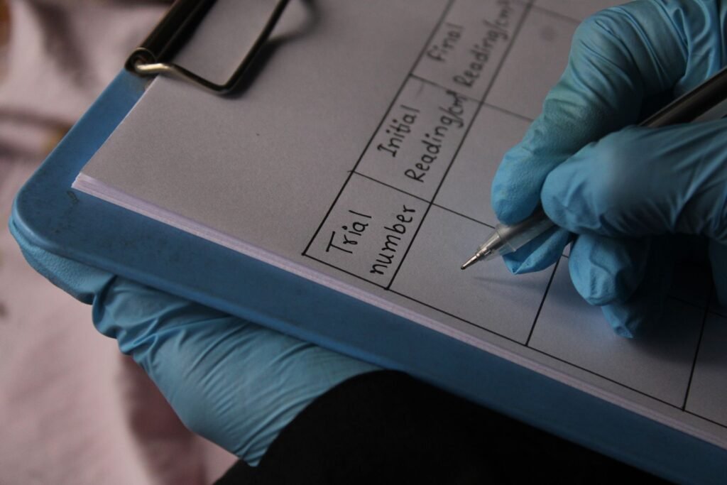 AFFF lawsuit: gloved hand filling out a medical data sheet on a clipboard