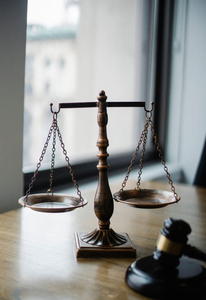 Filing a Bard PowerPort lawsuit: scales of justice and a gavel on a desk lit by a window
