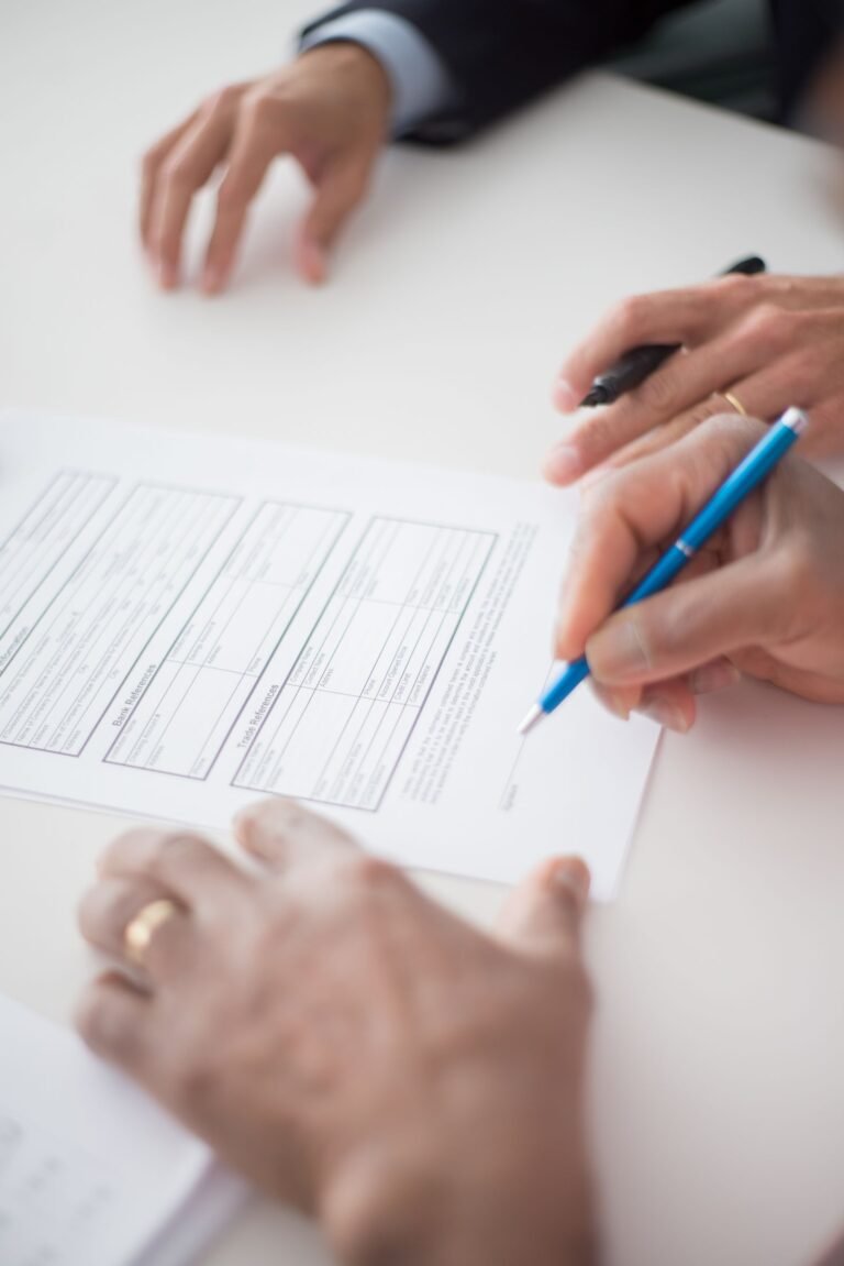 Edison Eaton Fire offer: close-up of hands holding a pen over a document before signing