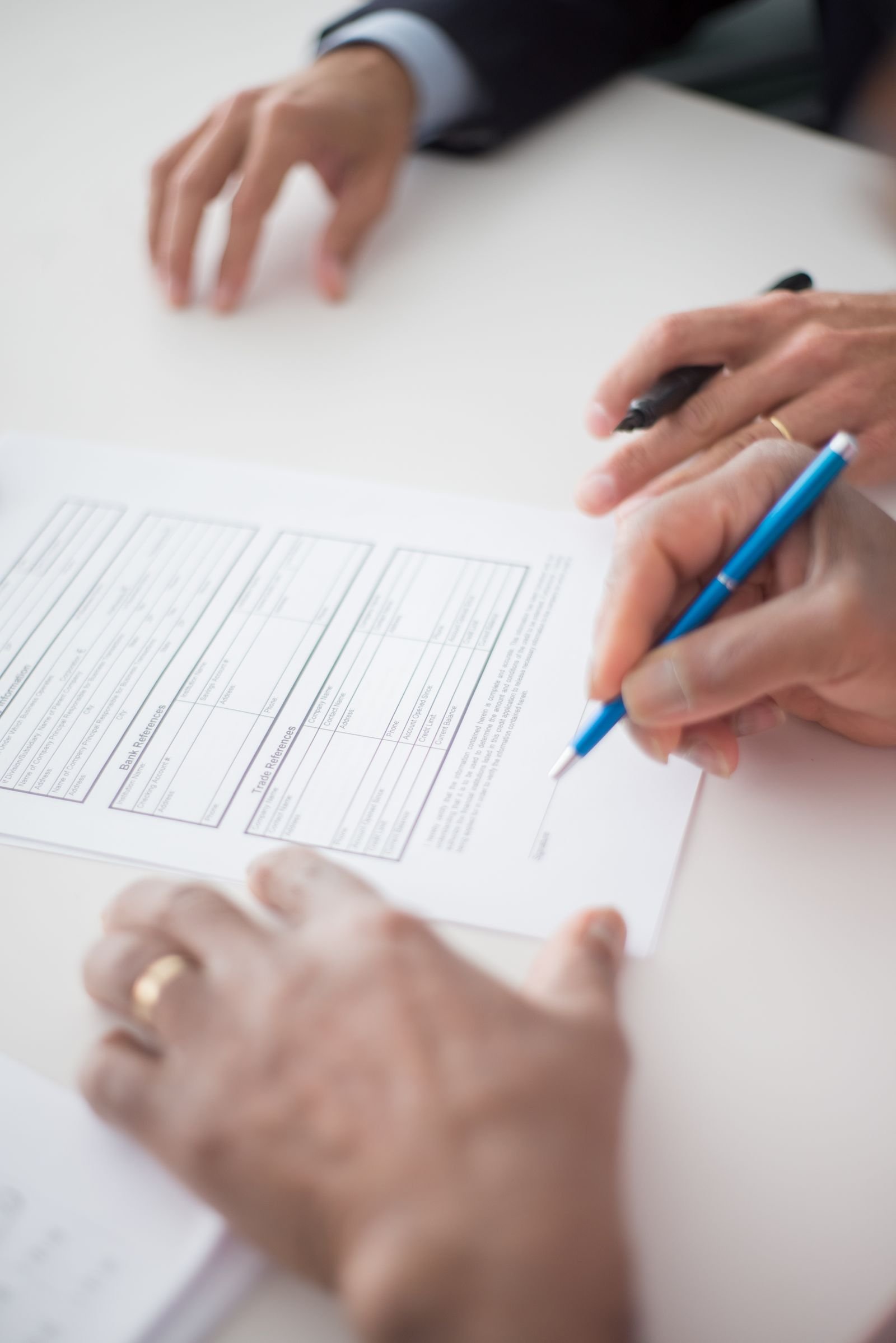Edison Eaton Fire offer: close-up of hands holding a pen over a document before signing
