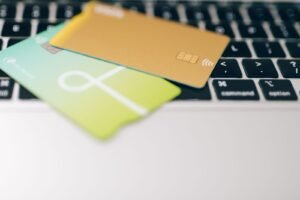 Roblox Robux addiction: two payment cards resting on a laptop keyboard, suggesting online purchases