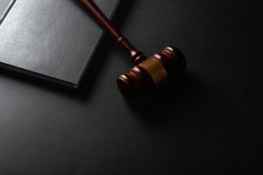 Cartiva lawsuit: wooden judge's gavel resting beside a closed book on a dark surface