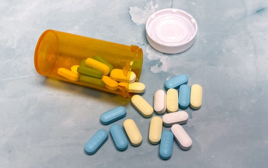 Depo-Provera brain tumor lawsuit: open prescription bottle with pills on a light blue surface
