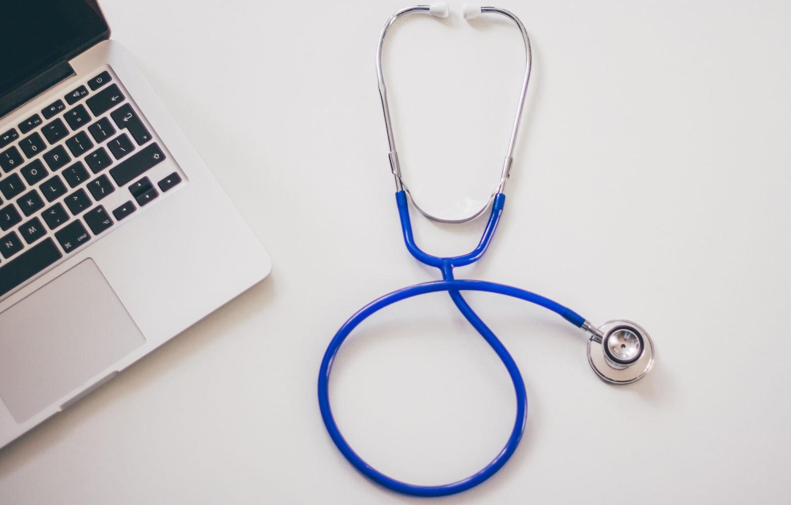 Depo-Provera lawsuits: stethoscope resting on a white desk next to a laptop