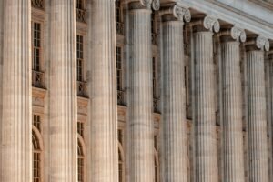CIW sexual abuse claim: stone courthouse facade with tall columns and a clock