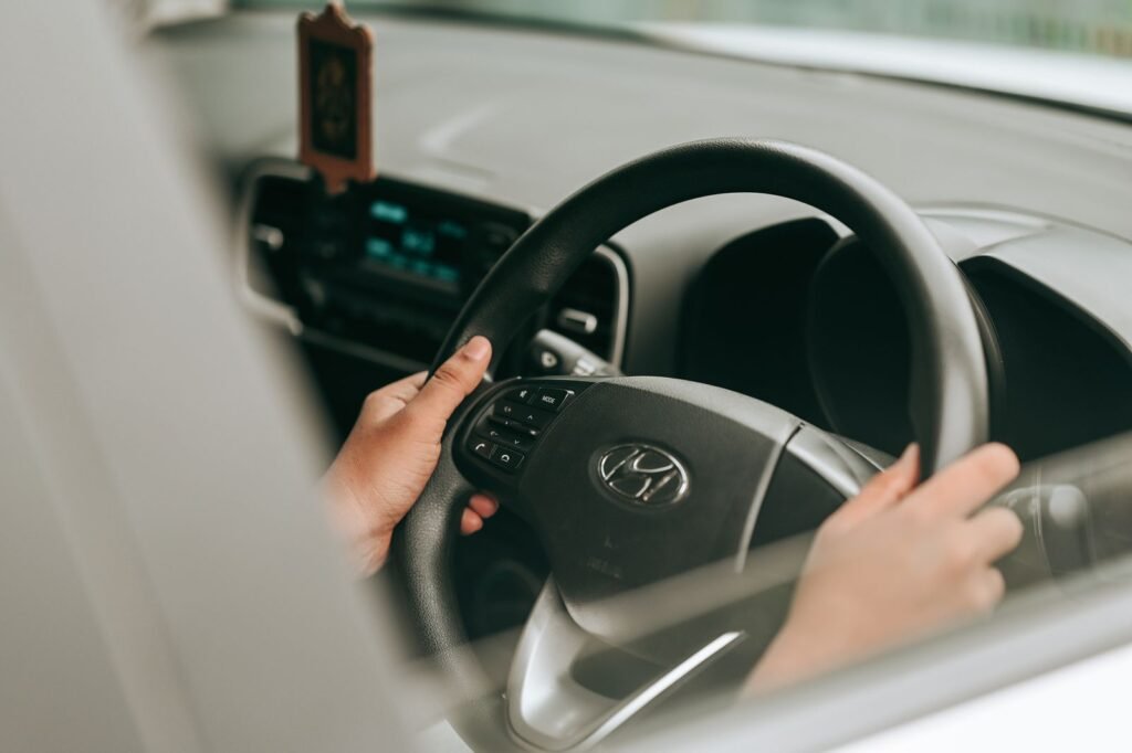 Rideshare driver injury claims: close-up of a driver's hands on a car steering wheel
