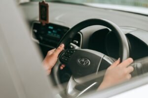 Rideshare driver injury claims: close-up of a driver's hands on a car steering wheel
