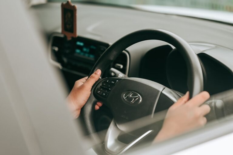 Rideshare driver injury claims: close-up of a driver's hands on a car steering wheel