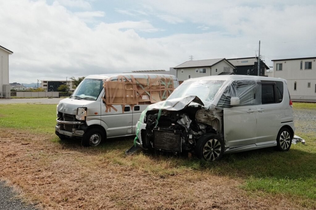 Rideshare driver injury claims: two damaged vans parked after a collision