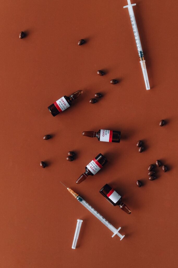 Dupixent FDA safety review: unbranded vials, syringes and tablets laid out on a colored surface