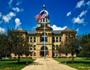 Dupixent lawsuit update: courthouse exterior with an American flag against a bright blue sky
