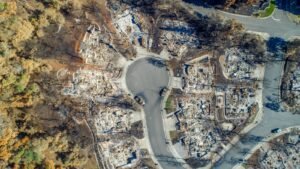 Utility wildfire settlements: aerial view of a California neighborhood with homes burned to their foundations after a wildfire