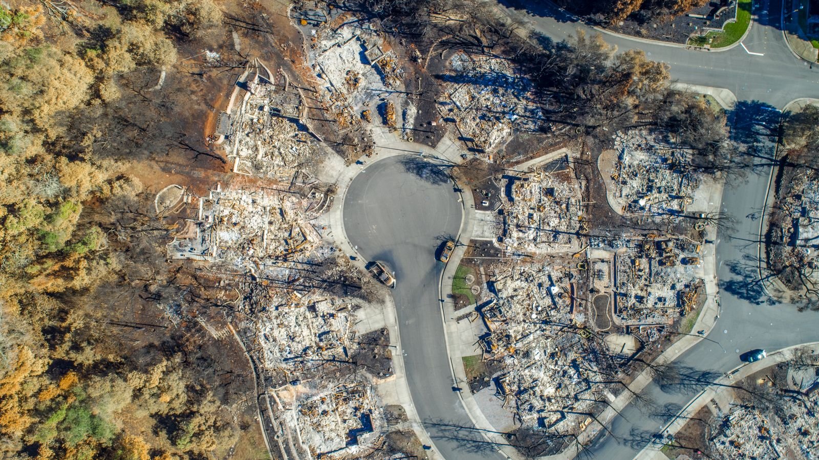 Utility wildfire settlements: aerial view of a California neighborhood with homes burned to their foundations after a wildfire