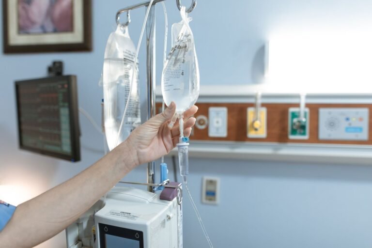 Bard PowerPort free case review: iV drip line and a patient's hand in a hospital room, face not shown