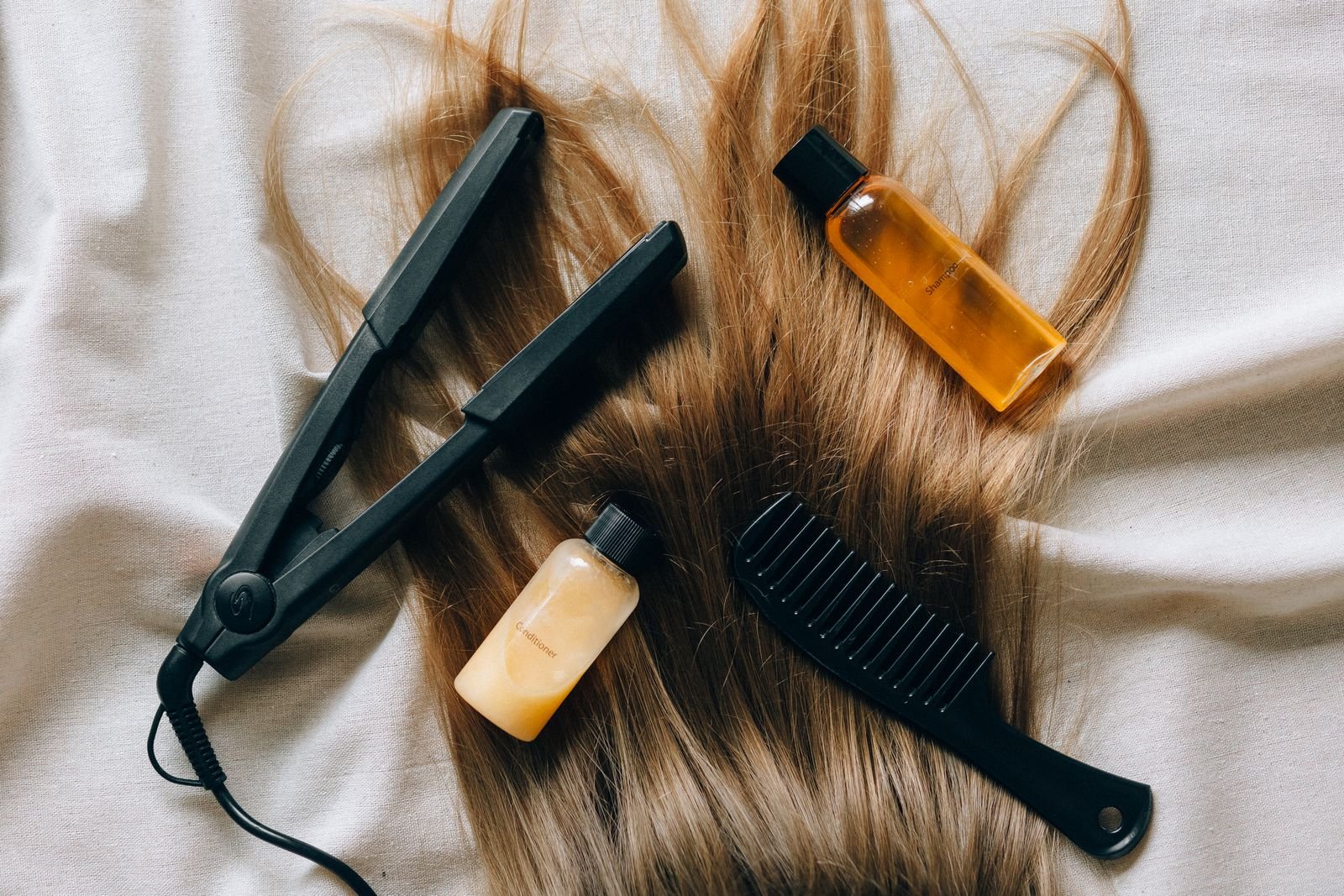 Hair relaxer MDL: flat lay of hair care bottles and styling tools on a table