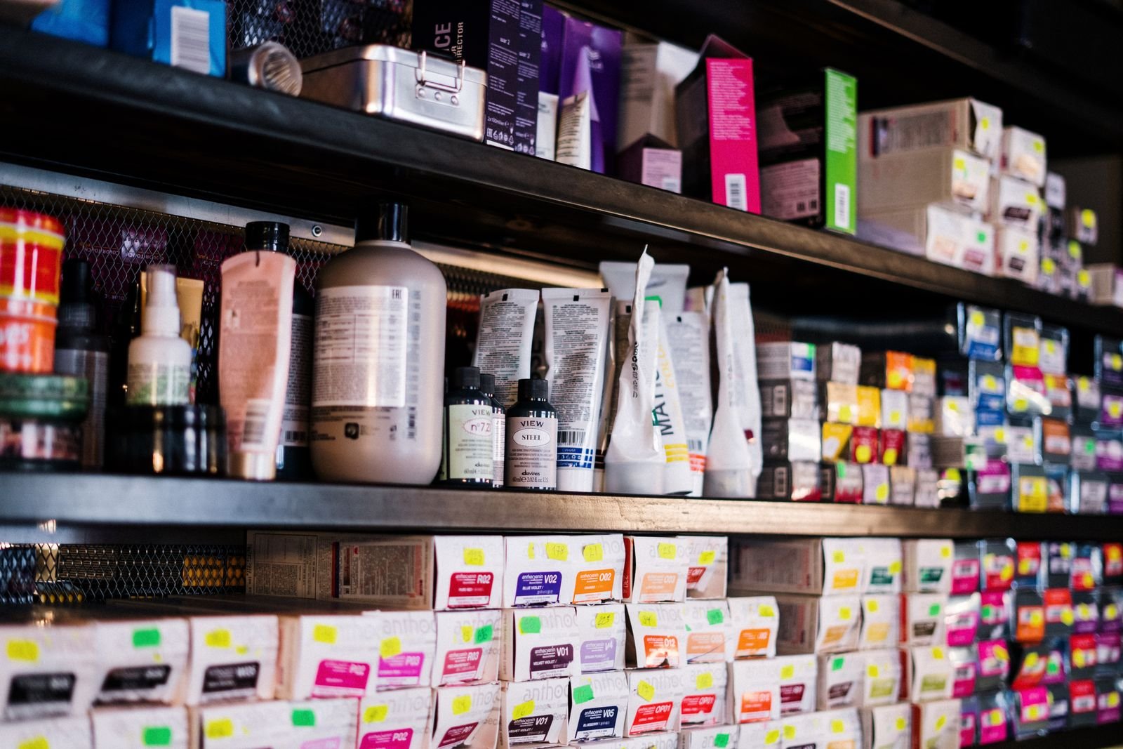 Hair relaxer lawsuits 2026: rows of hair care product bottles on a salon shelf