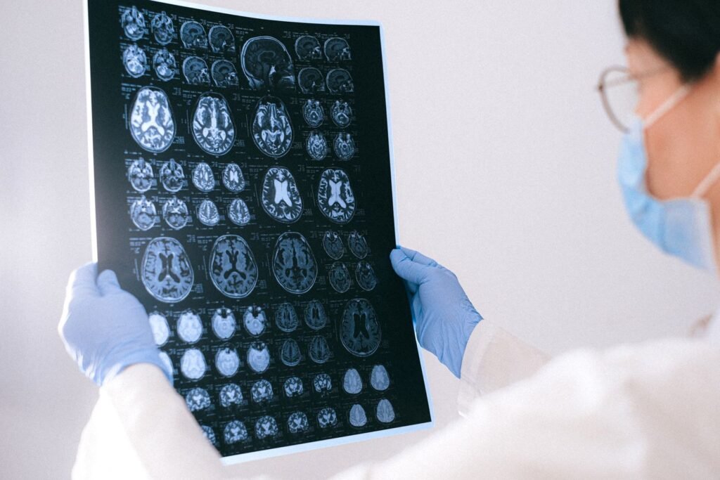 Depo-Provera brain tumor claims: hands holding brain MRI films up for review in a clinic