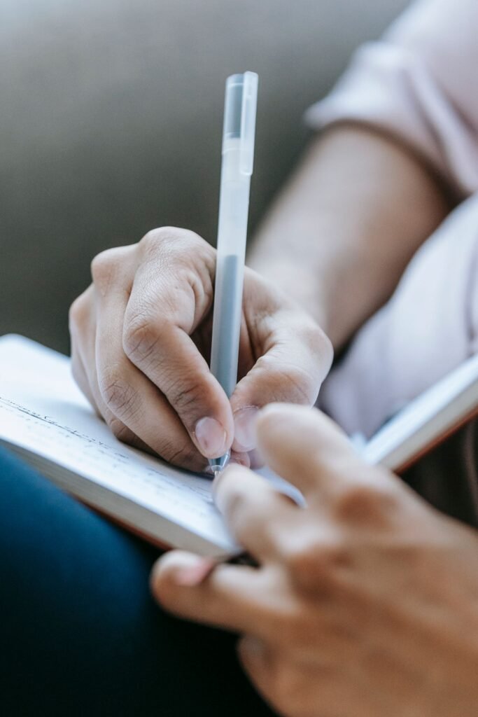 Depo-Provera brain tumor claims: close-up of a hand writing in a notebook, like keeping notes about years of treatment
