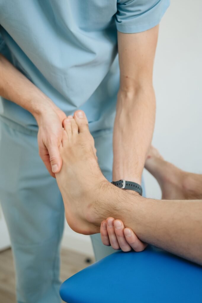 Cartiva toe implant patients: therapist's hands working on a patient's foot during a recovery session
