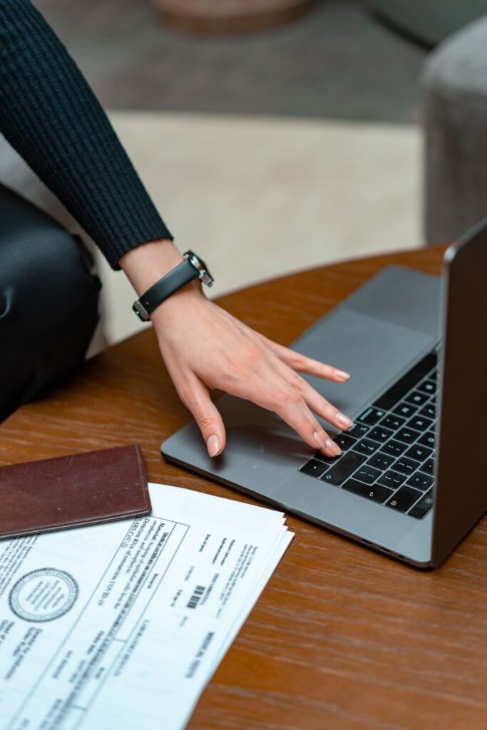 Car accident free case review: hands typing on a laptop beside paperwork on a table