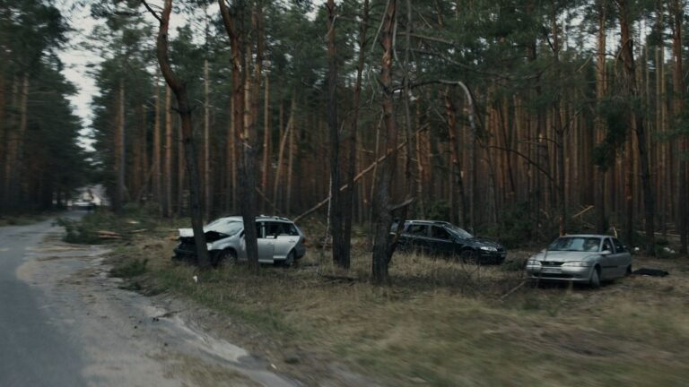 Uber or Lyft accident insurance: three damaged cars on a road after a collision