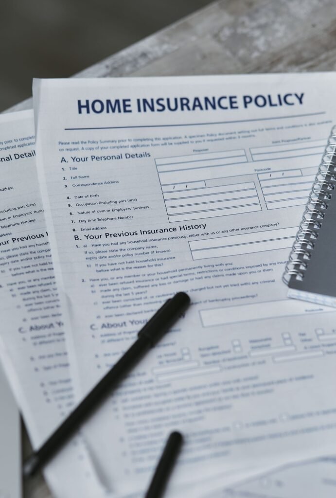 Uber or Lyft accident insurance: insurance policy form and notebook on a table, seen from above
