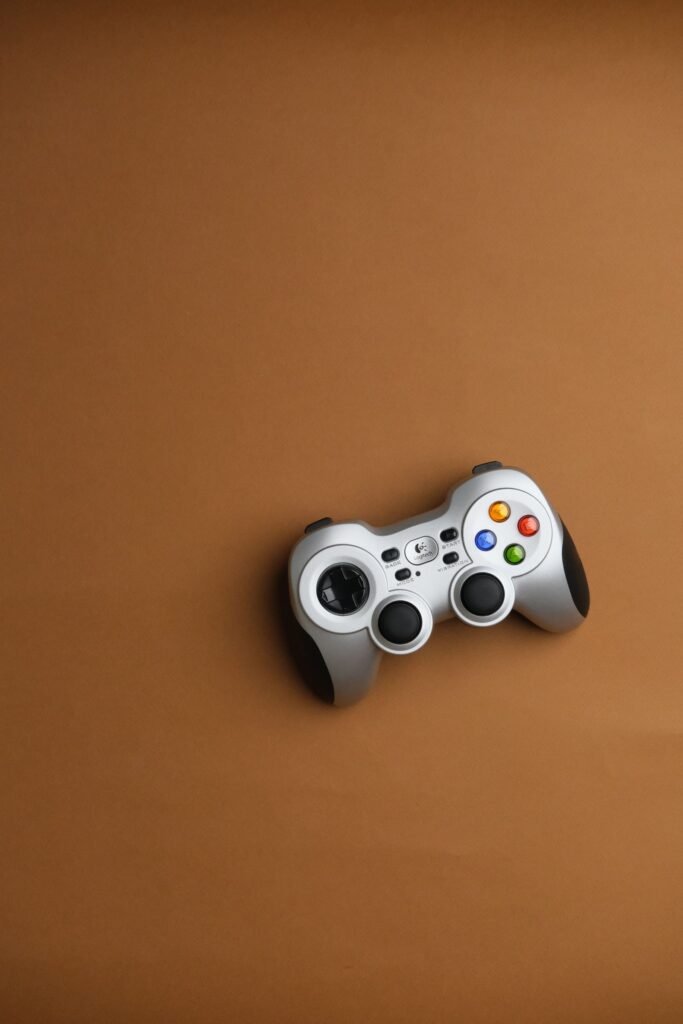 Roblox harm: a single wireless game controller on a plain brown background