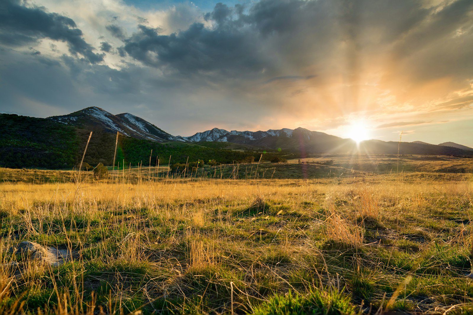 Sunset over the Wasatch mountains in Utah with green fields