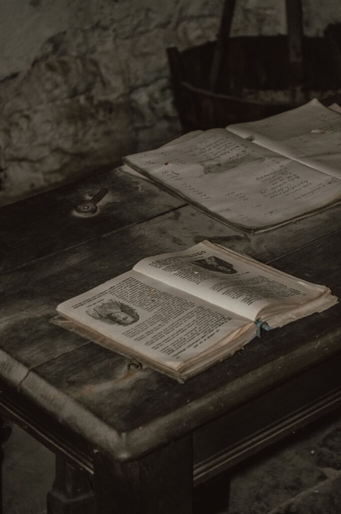LDS Church abuse lawsuit: several open vintage books lying on a rustic wooden table