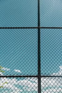 Maryland juvenile facility abuse: chain-link fence against a clear blue sky