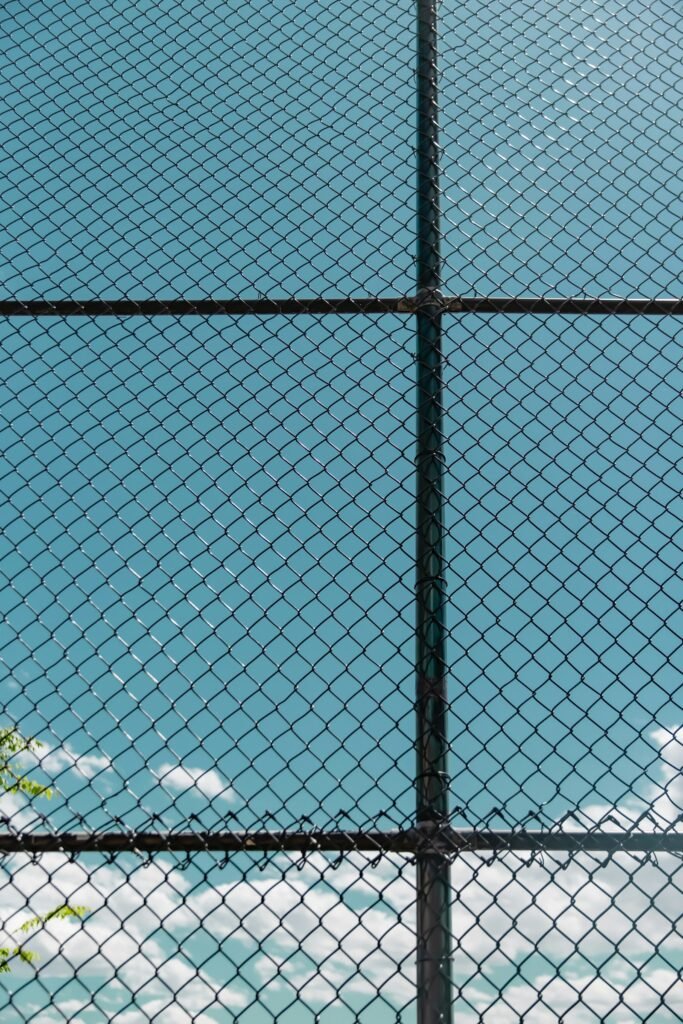 Maryland juvenile facility abuse: chain-link fence against a clear blue sky