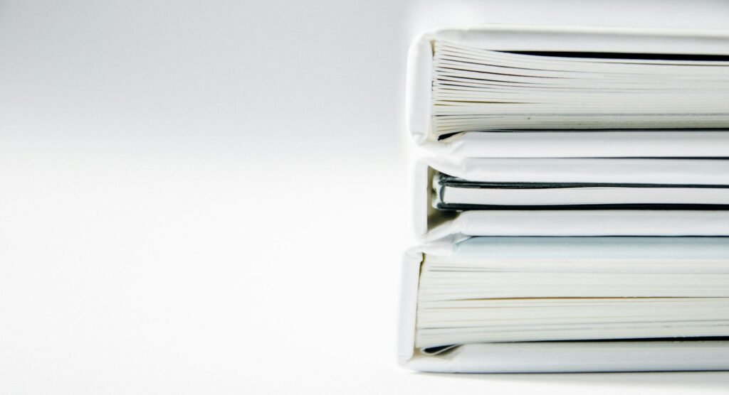 Northwell sleep center recording victims: stack of thick paper folders on a white surface