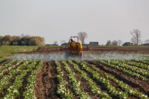 Paraquat lawsuit: tractor spraying a green farm field