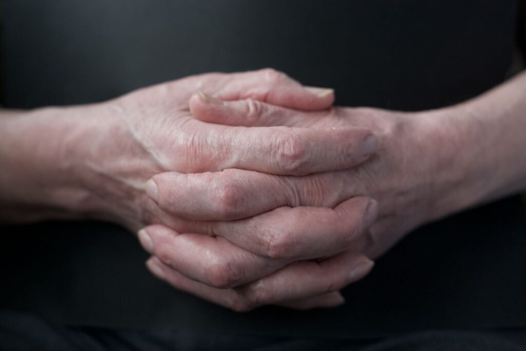 Paraquat lawsuit: close-up of an older adult's folded hands, face not shown