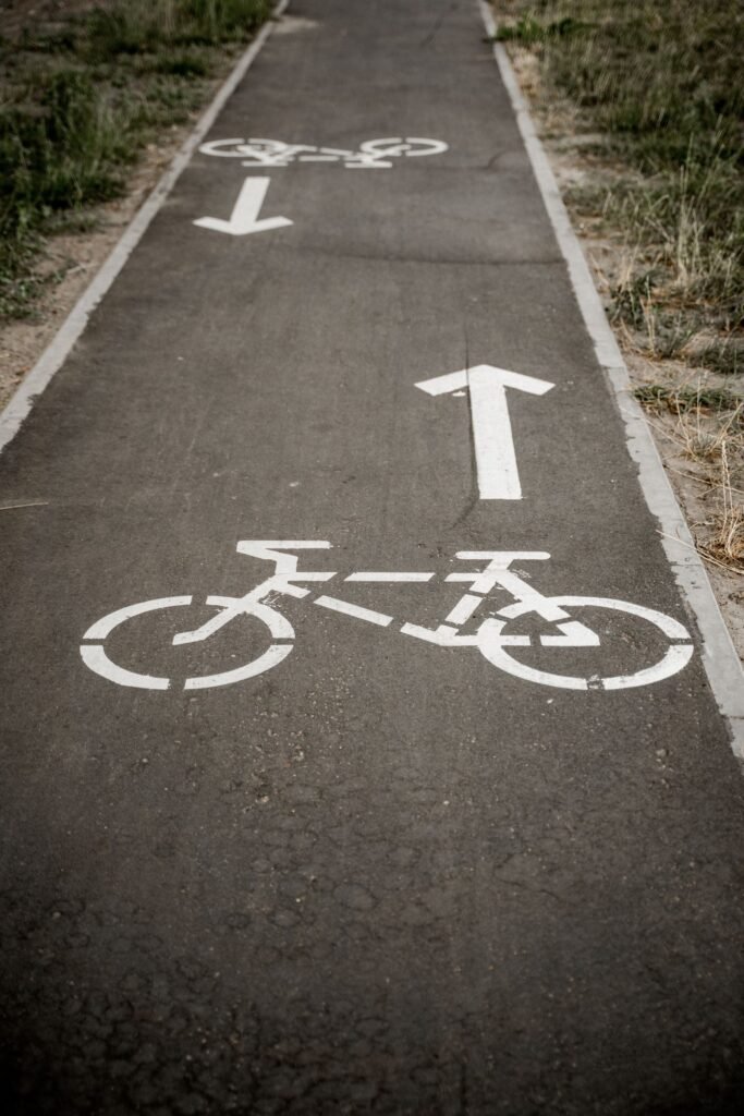 Pedestrian or cyclist injury: painted bicycle symbol and arrow marking a bike lane on asphalt