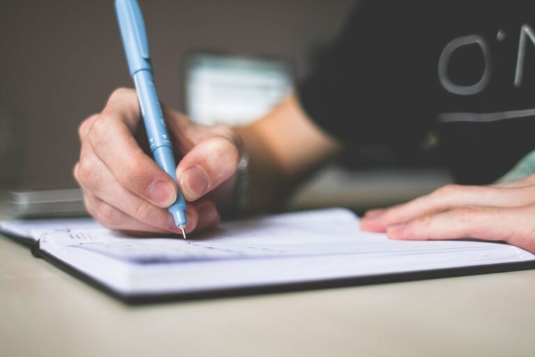 Depo-Provera injection records: hand writing notes in a notebook with a blue pen, like building a timeline of past visits