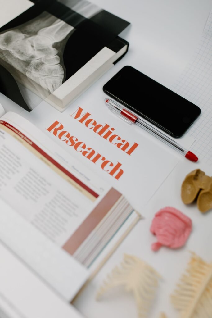Roundup science: flat lay of medical research books and study materials on a white surface