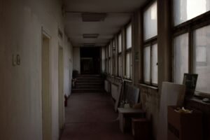 Maryland detention center abuse: long hallway of an old building lit by a row of windows