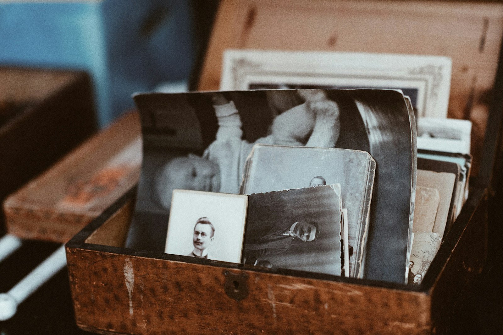 Talc legacy exposure: old family photographs piled inside a wooden chest