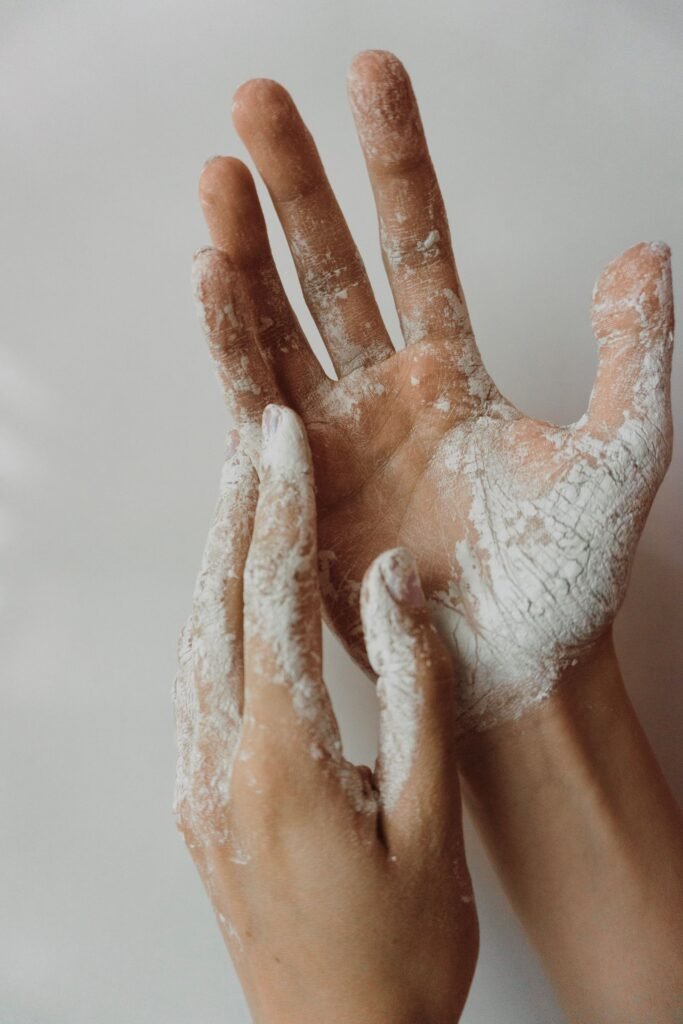 Talc legacy exposure: close-up of hands dusted with white powder
