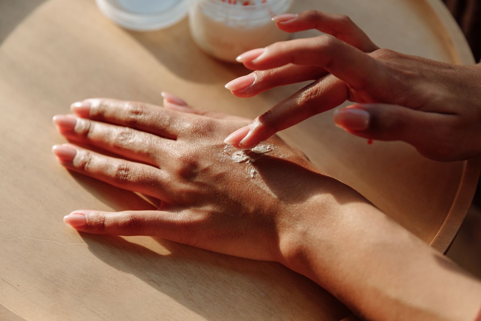Close-up of hands rubbing in moisturizing cream, a daily routine for people with eczema