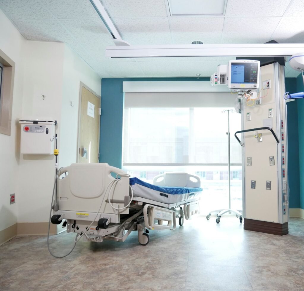 Living with a Bard PowerPort injury: empty hospital bed beside a large window with medical equipment
