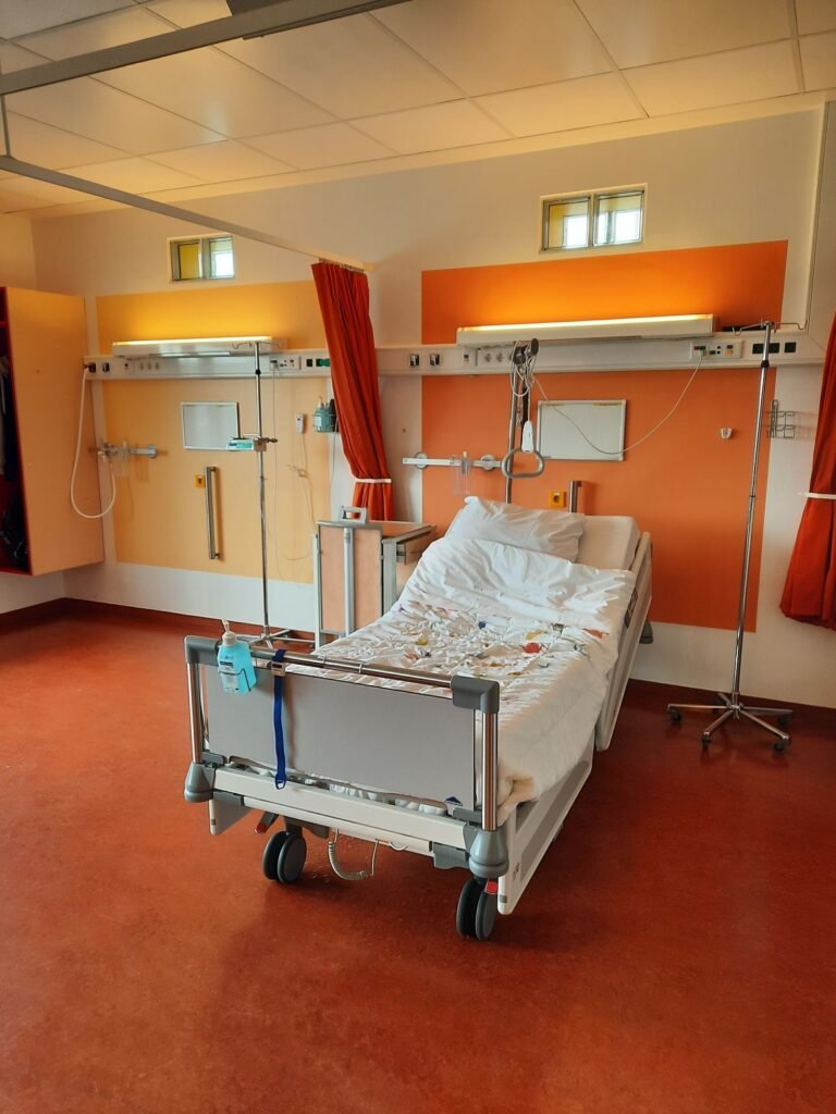 Transvaginal mesh lawsuit: empty hospital room with an adjustable bed and medical equipment