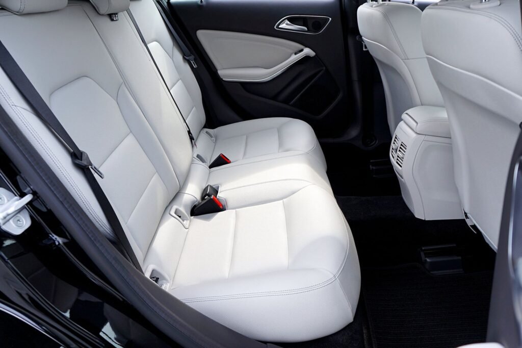 Uber and Lyft lawsuits: empty white leather seats inside a car