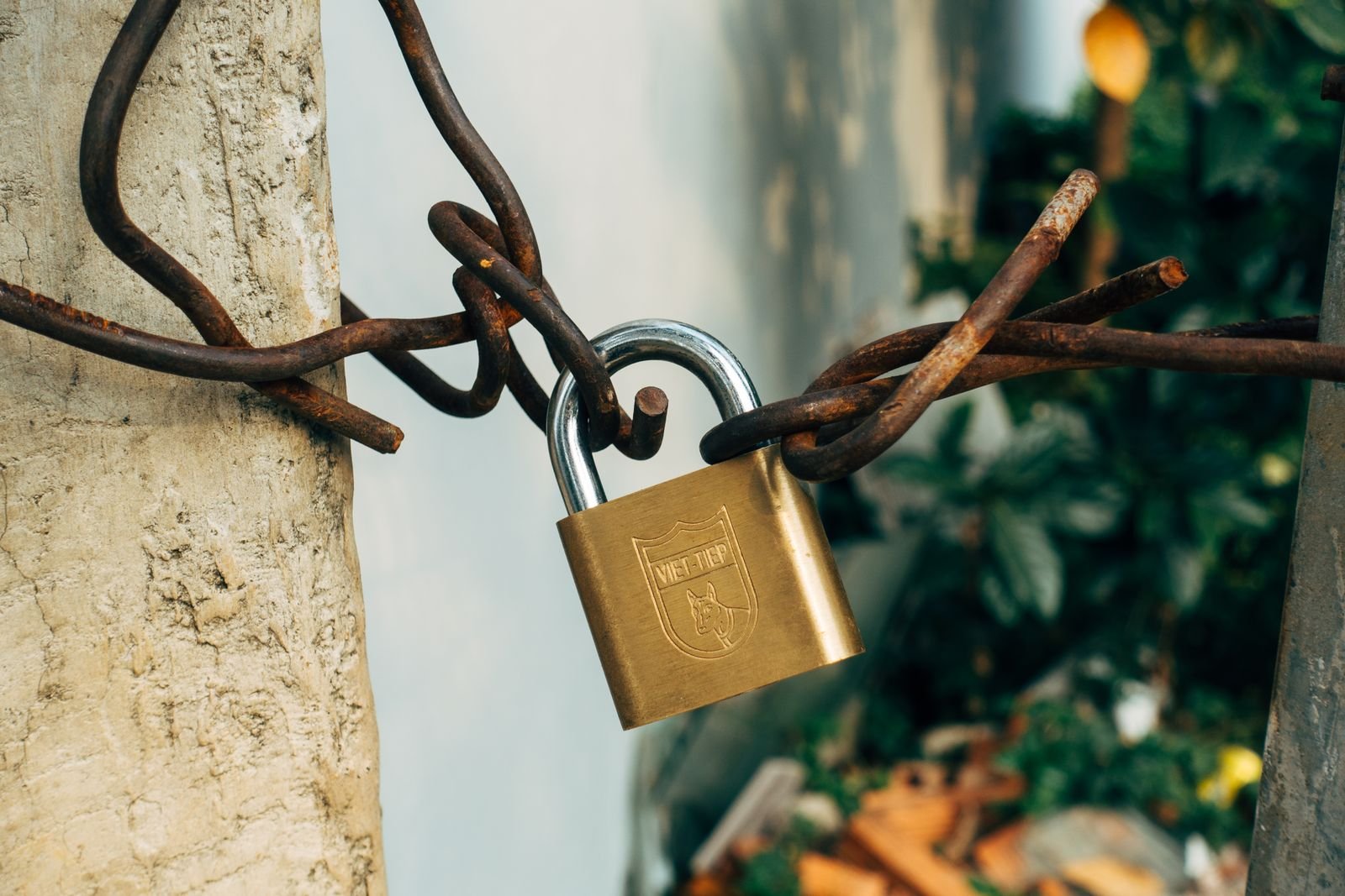 Roblox grooming lawsuit: brass padlock securing a weathered wire fence
