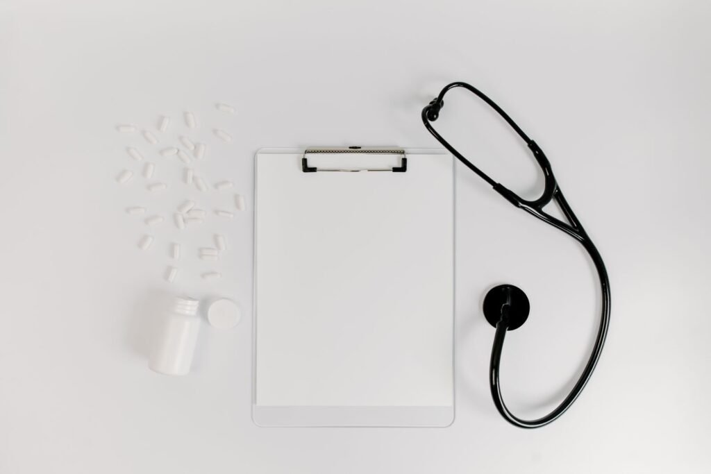Dupixent claim evidence: clipboard with a blank medical form beside a stethoscope and pills, representing medical records