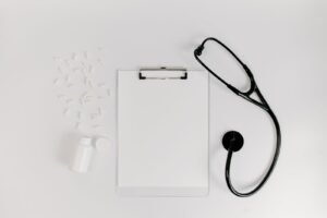 Dupixent claim evidence: clipboard with a blank medical form beside a stethoscope and pills, representing medical records