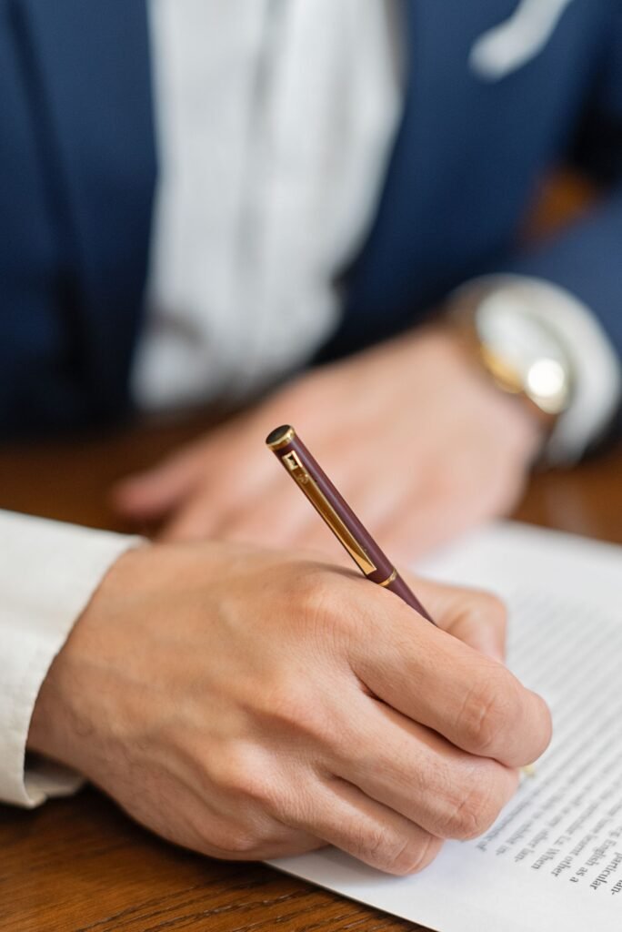 Depo-Provera settlement: close-up of a hand signing a formal document with a pen