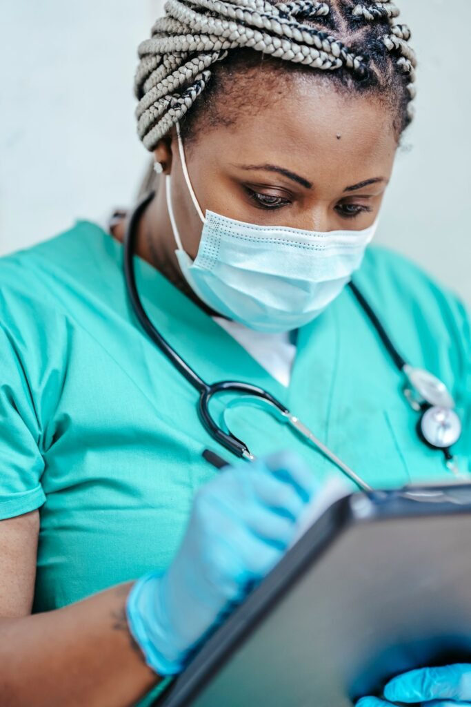Bard PowerPort claim documents: gloved hands of a health care worker writing on a clipboard
